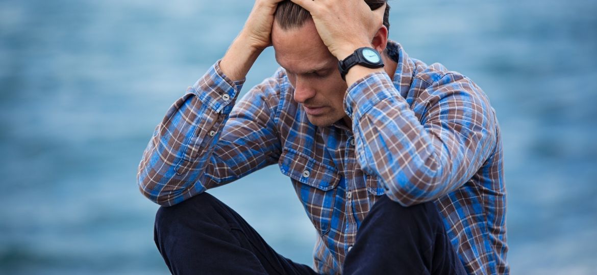 man-in-blue-and-brown-plaid-dress-shirt-touching-his-hair-897817